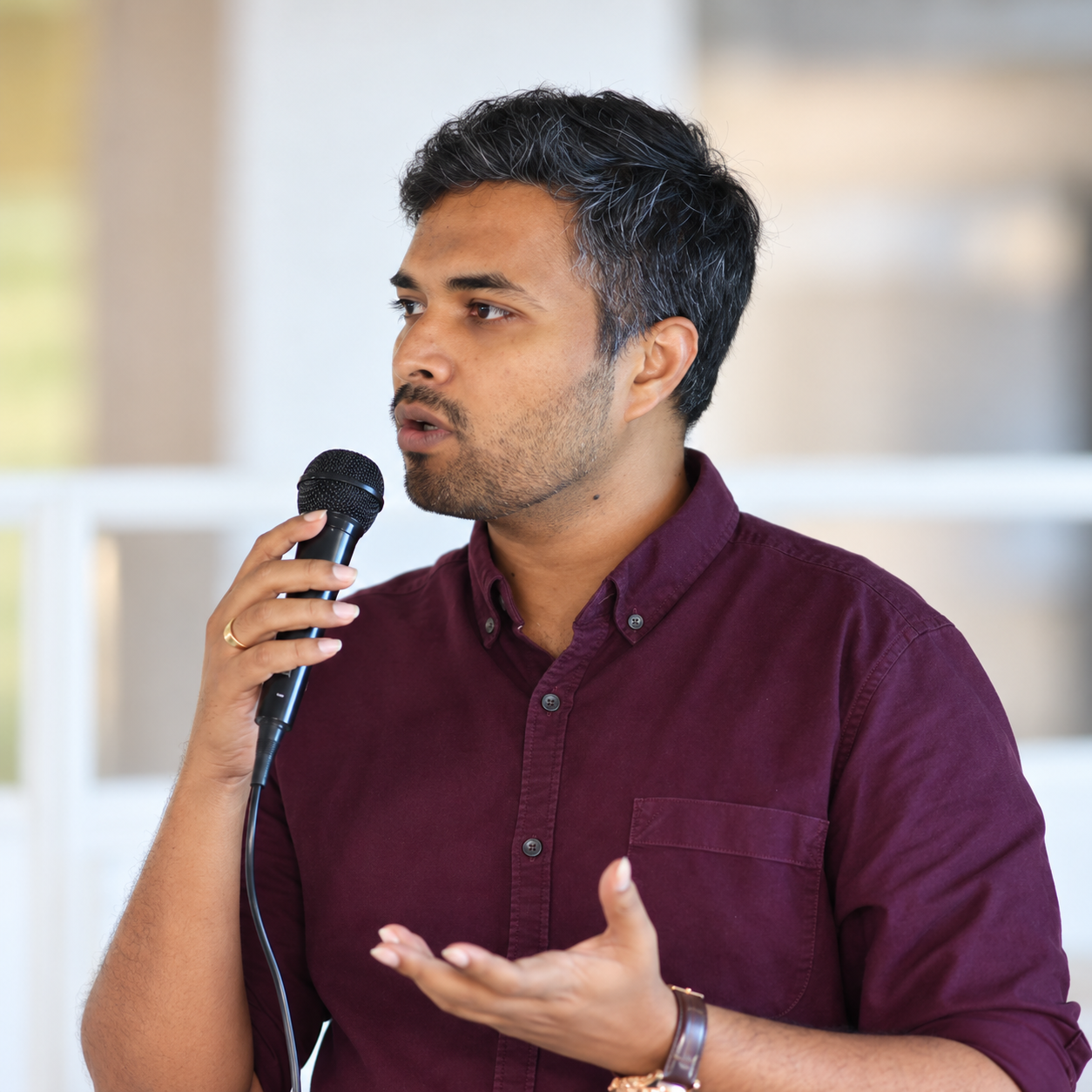 Rahul Thota speaking into a microphone